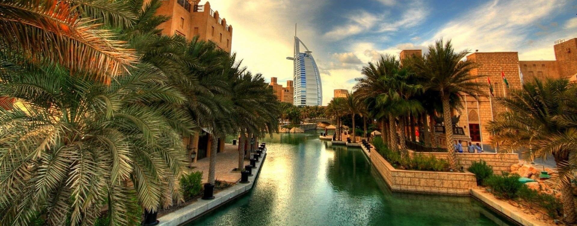 The Burj Al Arab viewed along the Madinat Jumeirah waterway at golden hour
