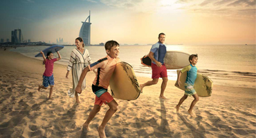 Family beach day with Burj Al Arab in the background